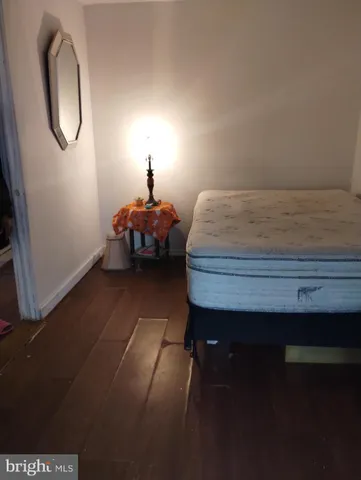 a bedroom with a bed and a mirror