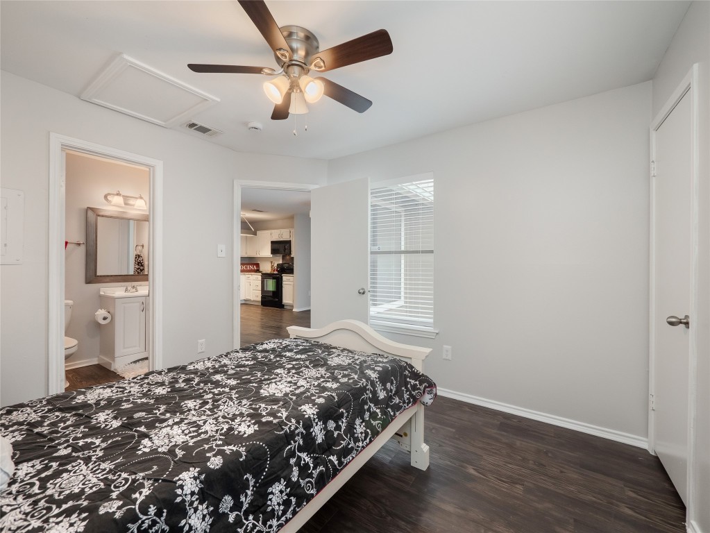 1740 Timber Ridge Road, Unit 132 Austin, TX 78741 - Photo 15 of 26 a bedroom with a large bed and a chandelier fan