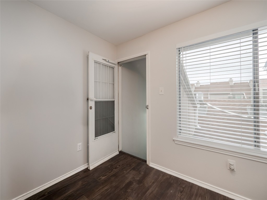 1740 Timber Ridge Road, Unit 132 Austin, TX 78741 - Photo 17 of 26 a view of an empty room with wooden floor and a window