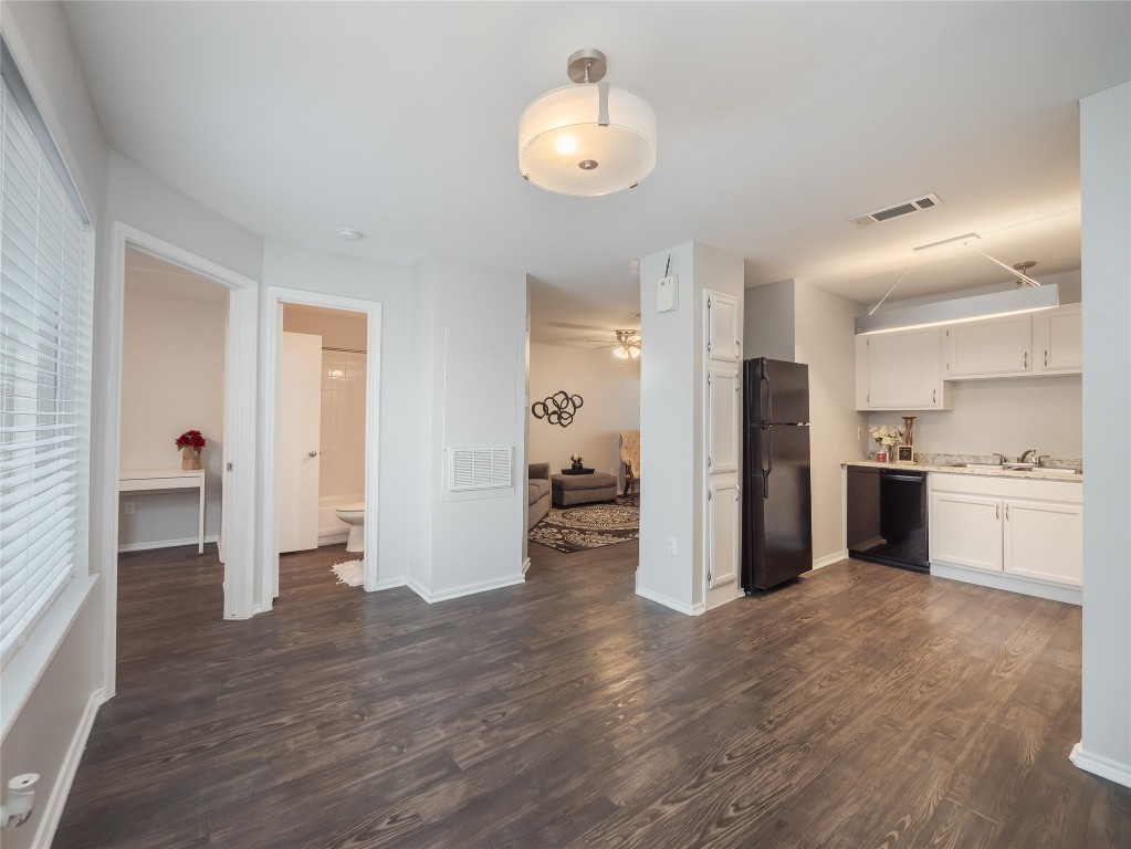 1740 Timber Ridge Road, Unit 132 Austin, TX 78741 - Photo 7 of 26 a view of a kitchen with refrigerator and wooden floor