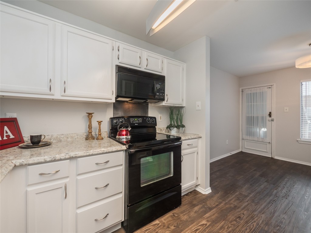 1740 Timber Ridge Road, Unit 132 Austin, TX 78741 - Photo 9 of 26 a kitchen with granite countertop a sink a stove and cabinets