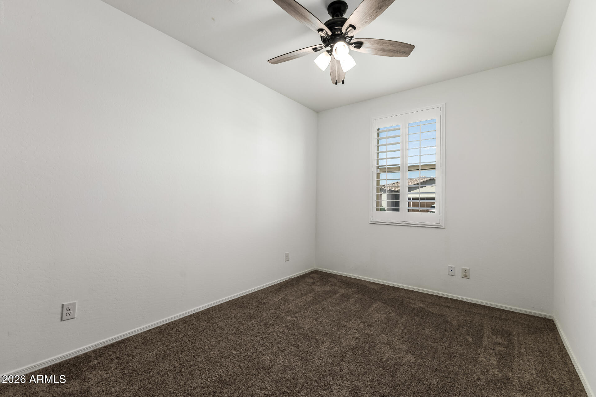 44157 West Palo Olmo Road Maricopa, AZ 85138 - Photo 13 of 34 an empty room with windows and fan
