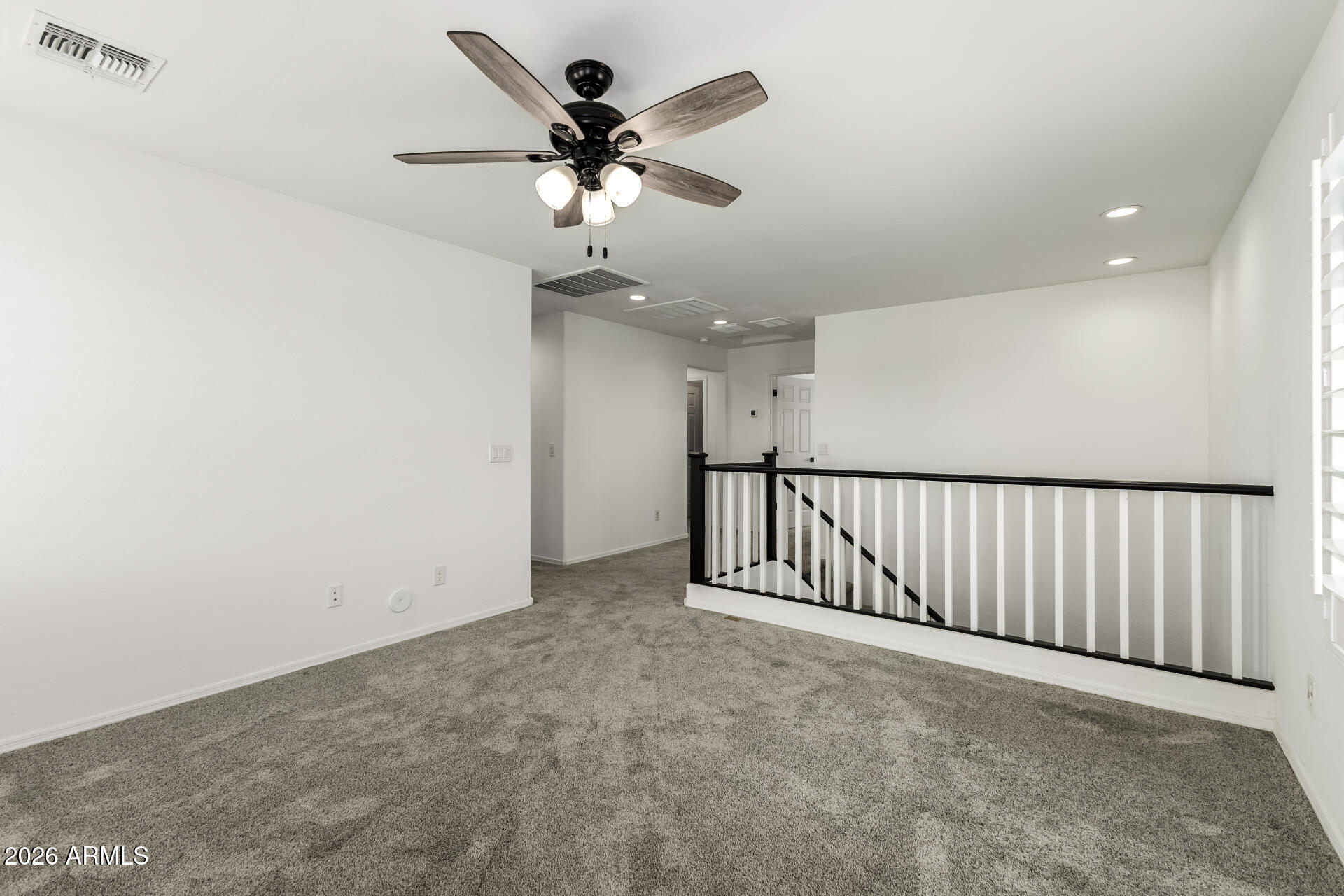44157 West Palo Olmo Road Maricopa, AZ 85138 - Photo 16 of 34 a view of a hallway with a ceiling fan