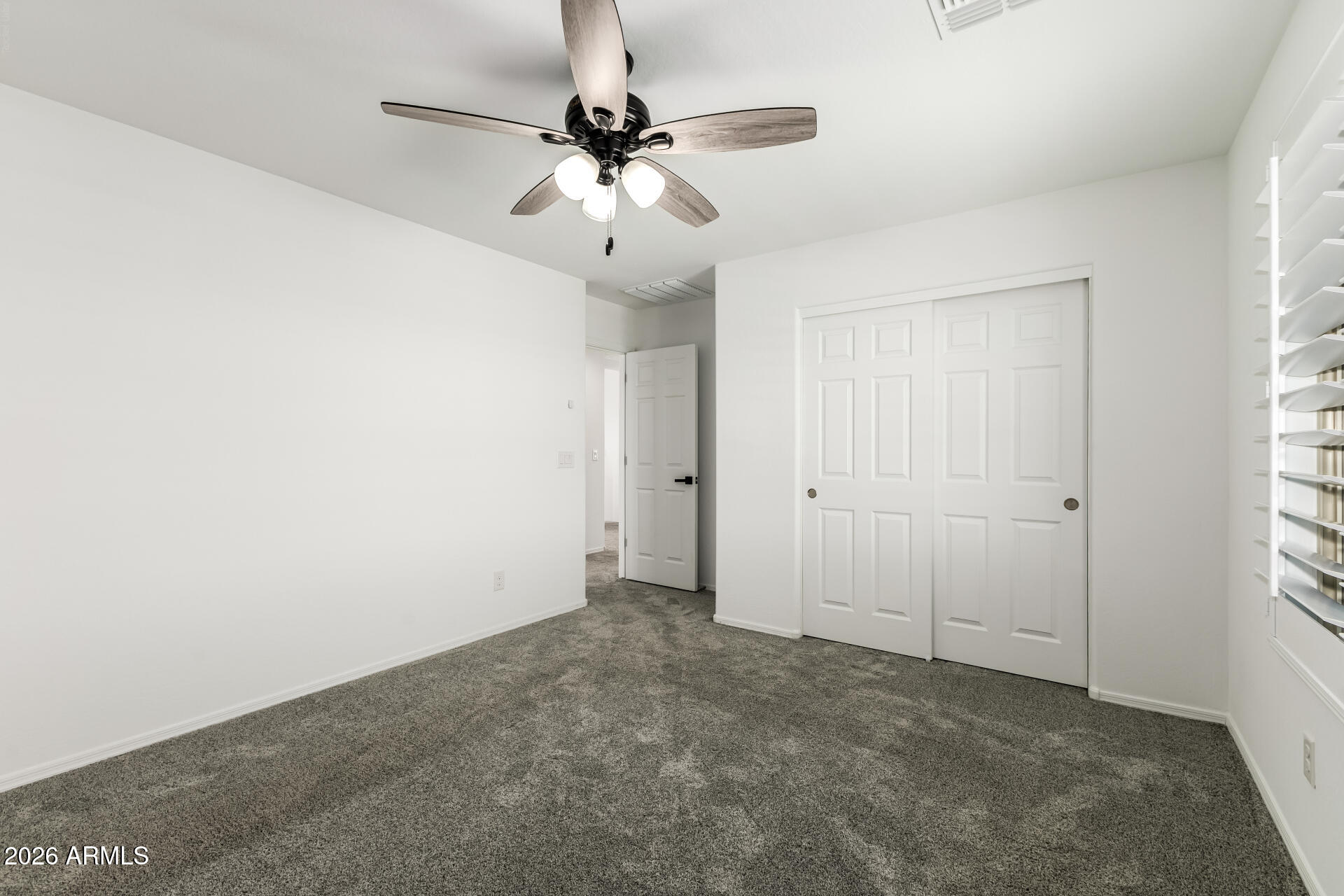 44157 West Palo Olmo Road Maricopa, AZ 85138 - Photo 24 of 34 an empty room with a window and a fan