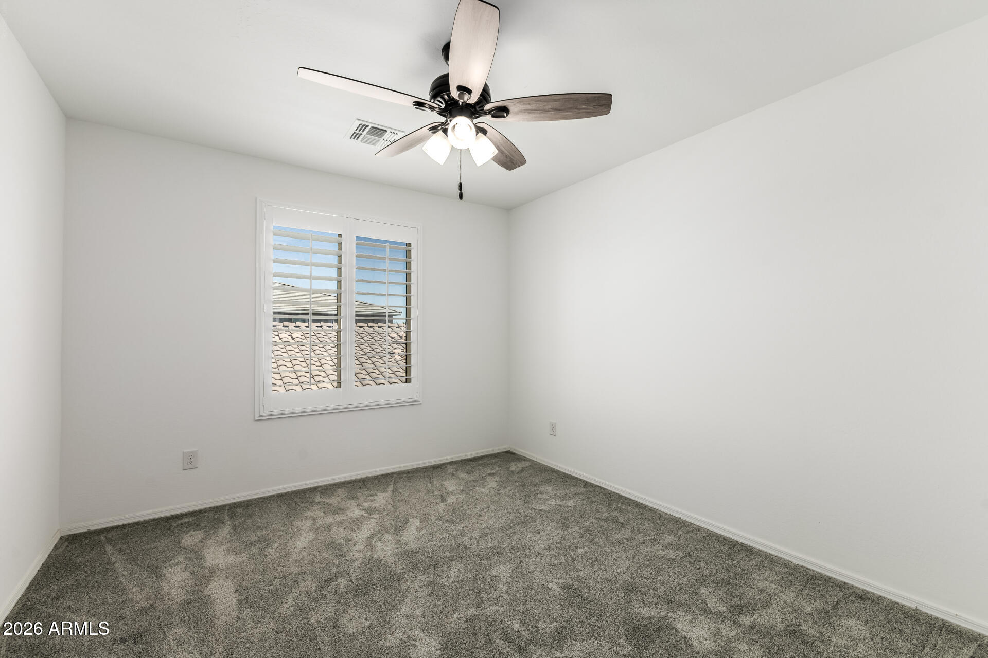 44157 West Palo Olmo Road Maricopa, AZ 85138 - Photo 25 of 34 an empty room with a ceiling fan and window