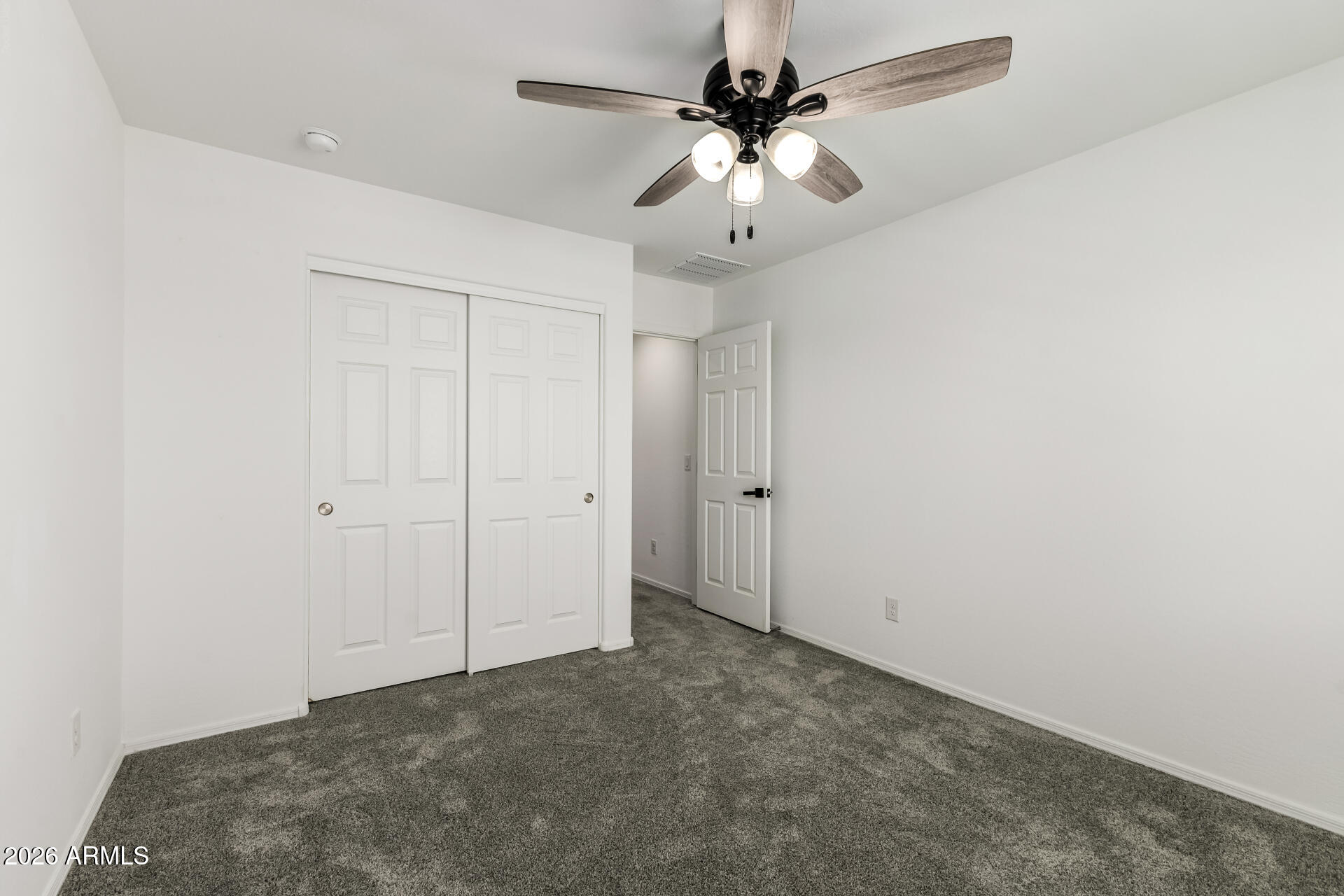 44157 West Palo Olmo Road Maricopa, AZ 85138 - Photo 28 of 34 an empty room with a chandelier fan and a ceiling fan