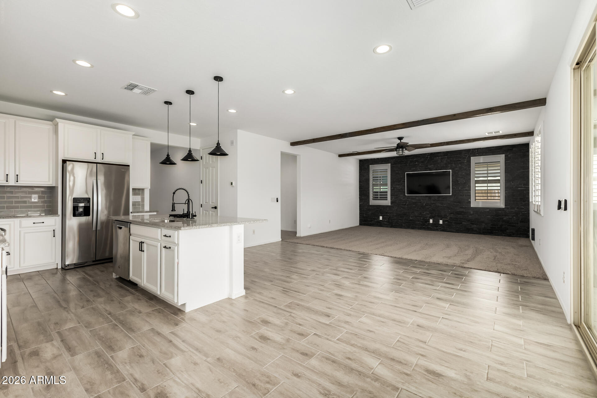44157 West Palo Olmo Road Maricopa, AZ 85138 - Photo 7 of 34 a large white kitchen with white cabinets and stainless steel appliances