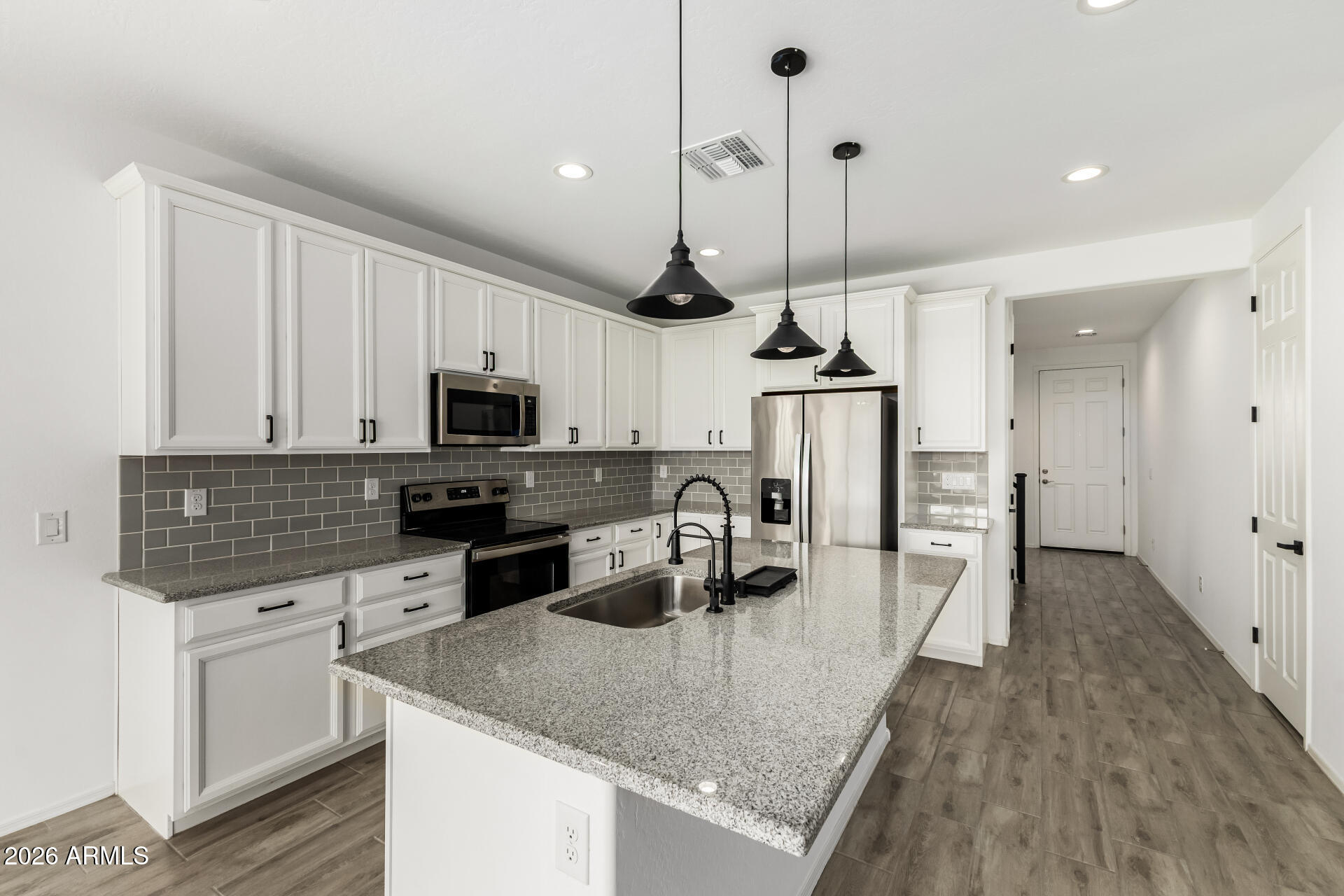 44157 West Palo Olmo Road Maricopa, AZ 85138 - Photo 10 of 34 a kitchen with stainless steel appliances granite countertop a sink a stove and refrigerator