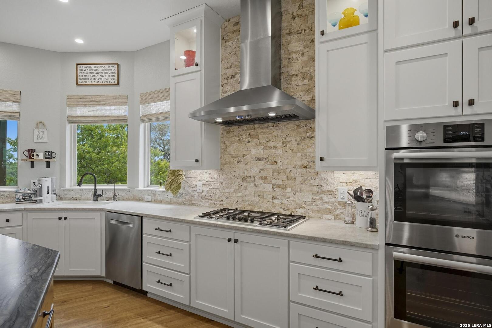 134 Stallion Estates Drive Spring Branch, TX 78070 - Photo 18 of 67 a kitchen with stainless steel appliances white cabinets and a stove