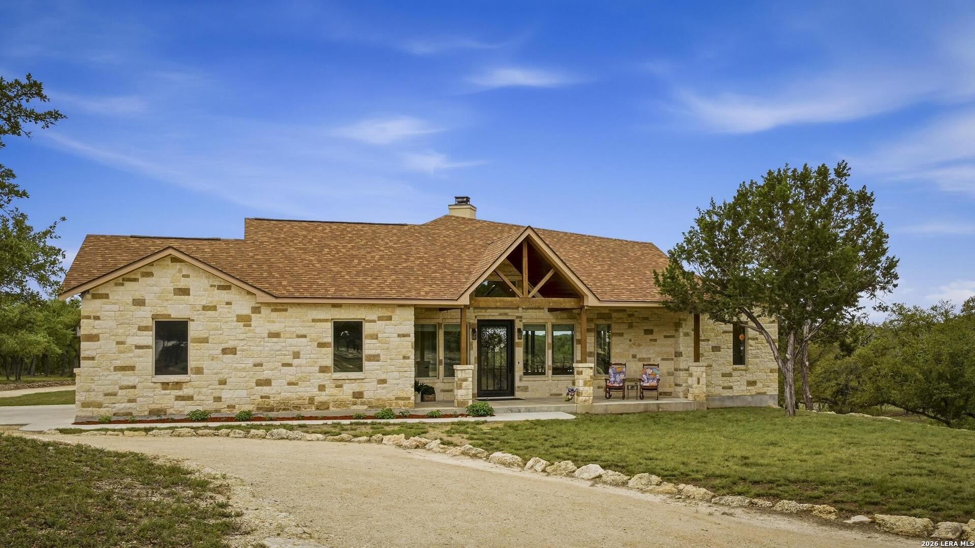 134 Stallion Estates Drive Spring Branch, TX 78070 - Photo 2 of 67 a front view of a house with a garden