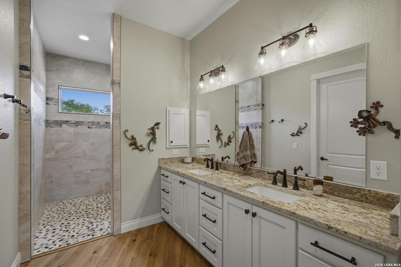 134 Stallion Estates Drive Spring Branch, TX 78070 - Photo 24 of 67 a bathroom with a granite countertop sink mirror and double