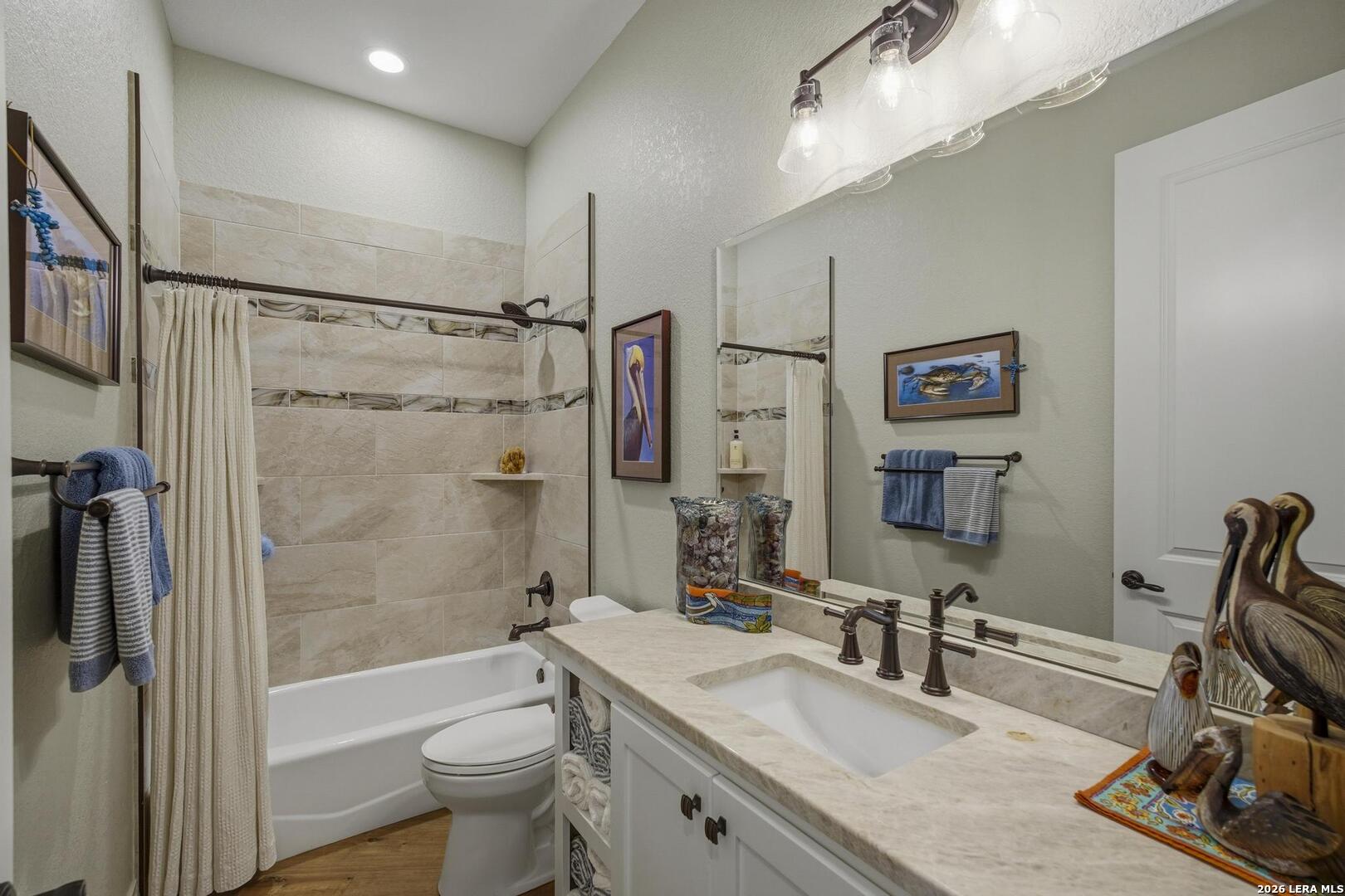 134 Stallion Estates Drive Spring Branch, TX 78070 - Photo 27 of 67 a bathroom with a granite countertop sink toilet and shower
