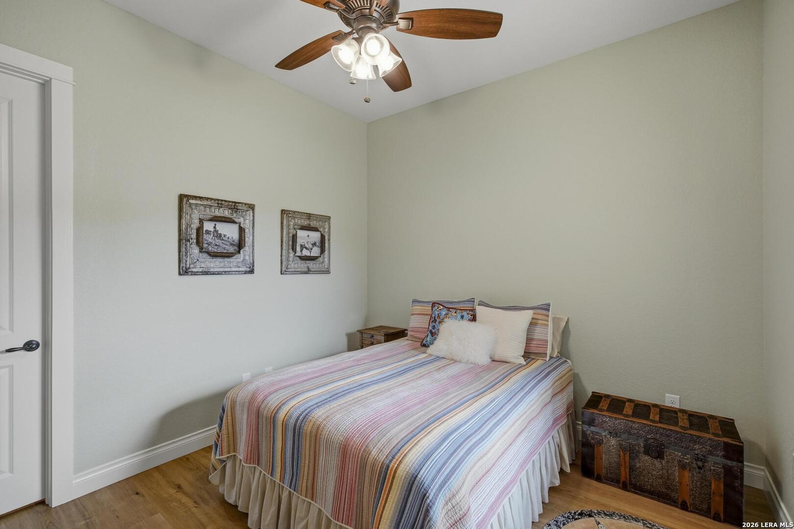 134 Stallion Estates Drive Spring Branch, TX 78070 - Photo 28 of 67 a bedroom with a bed and a chandelier