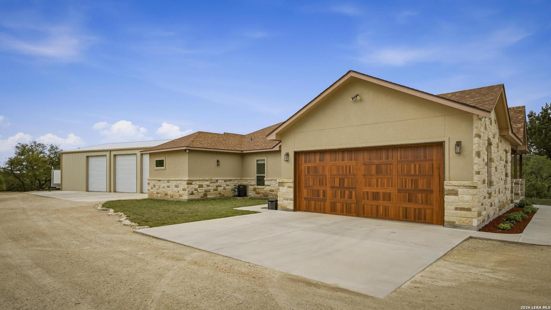 134 Stallion Estates Drive Spring Branch, TX 78070 - Photo 38 of 67 a front view of a house with a yard and garage