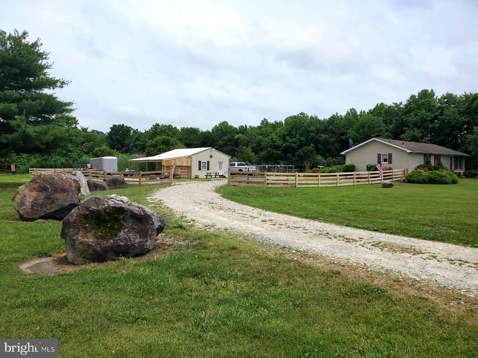 269 Walker School Road Townsend, DE 19734 - Photo 10 of 57 Curved driveway with six decorative boulders