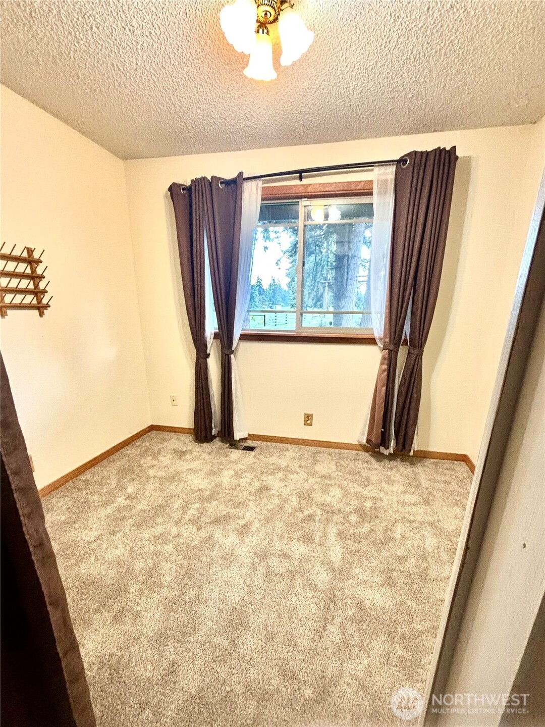9844 173rd Avenue Southwest Rochester, WA 98579 - Photo 13 of 38 a view of empty room with wooden floor and fan