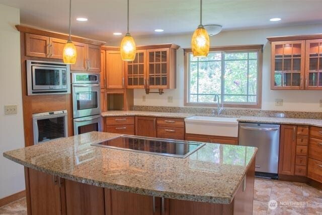 9844 173rd Avenue Southwest Rochester, WA 98579 - Photo 8 of 38 a kitchen with stainless steel appliances granite countertop a kitchen island a stove and a sink