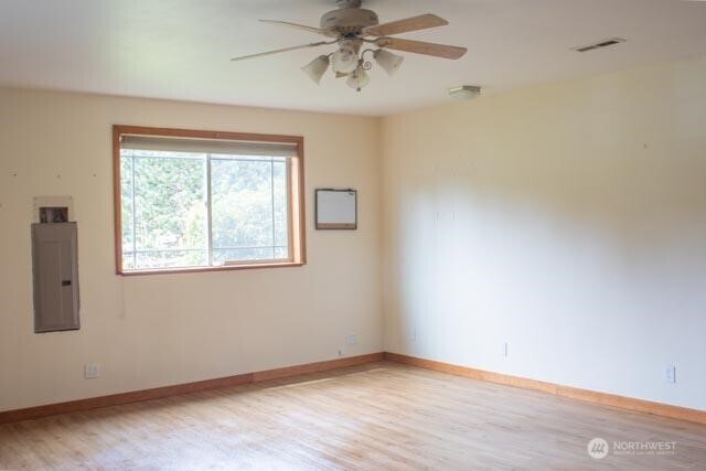 9844 173rd Avenue Southwest Rochester, WA 98579 - Photo 9 of 38 an empty room with a window and a ceiling fan