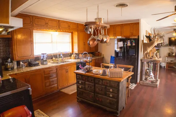 a kitchen with stainless steel appliances granite countertop a stove and a refrigerator