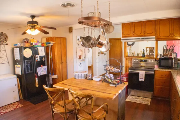 a view of a dining room with furniture a chandelier and wooden floor