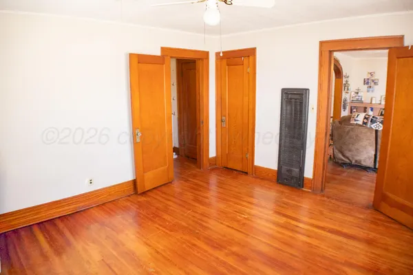 a bedroom with a bed next to a window