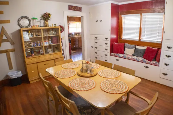 a dining room with furniture and wooden floor
