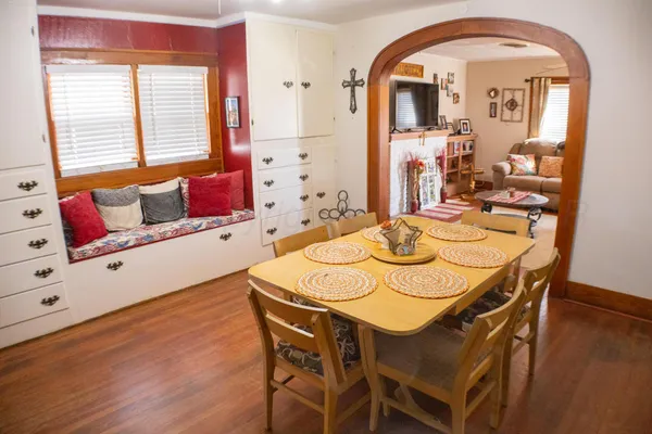 a view of a dining room with furniture and wooden floor