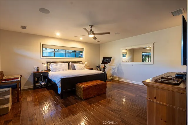 a bedroom with bed and wooden floor