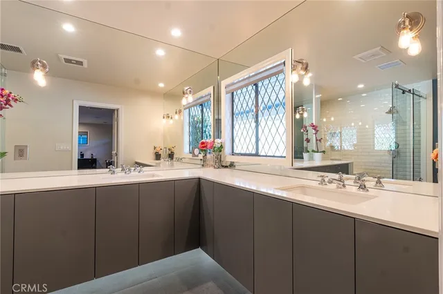 a bathroom with a sink double vanity and a mirror