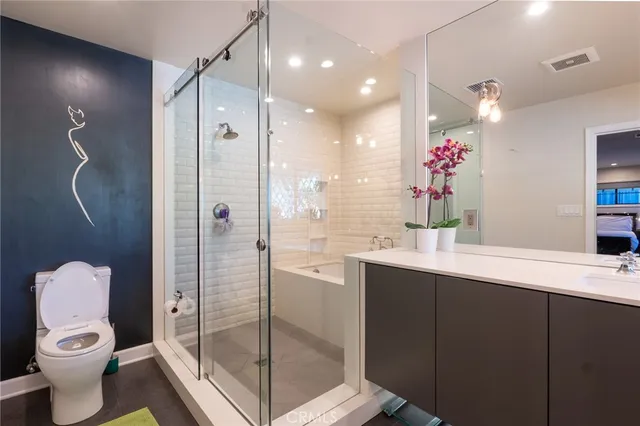 a bathroom with a toilet sink and shower