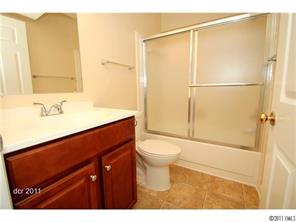 11038 Running Ridge Road, Unit 8421 Charlotte, NC 28226 - Photo 11 of 16 a bathroom with a sink a toilet and shower