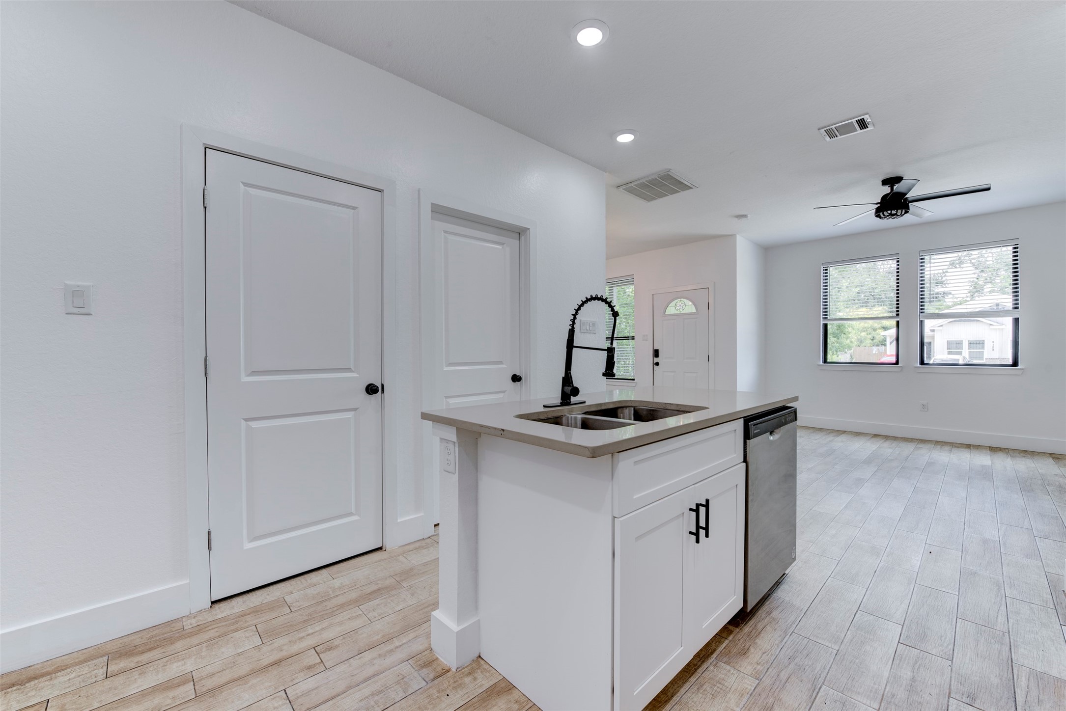5121 Southwind Street, Unit B Houston, TX 77033 - Photo 12 of 24 a kitchen with stainless steel appliances a sink and wooden floor