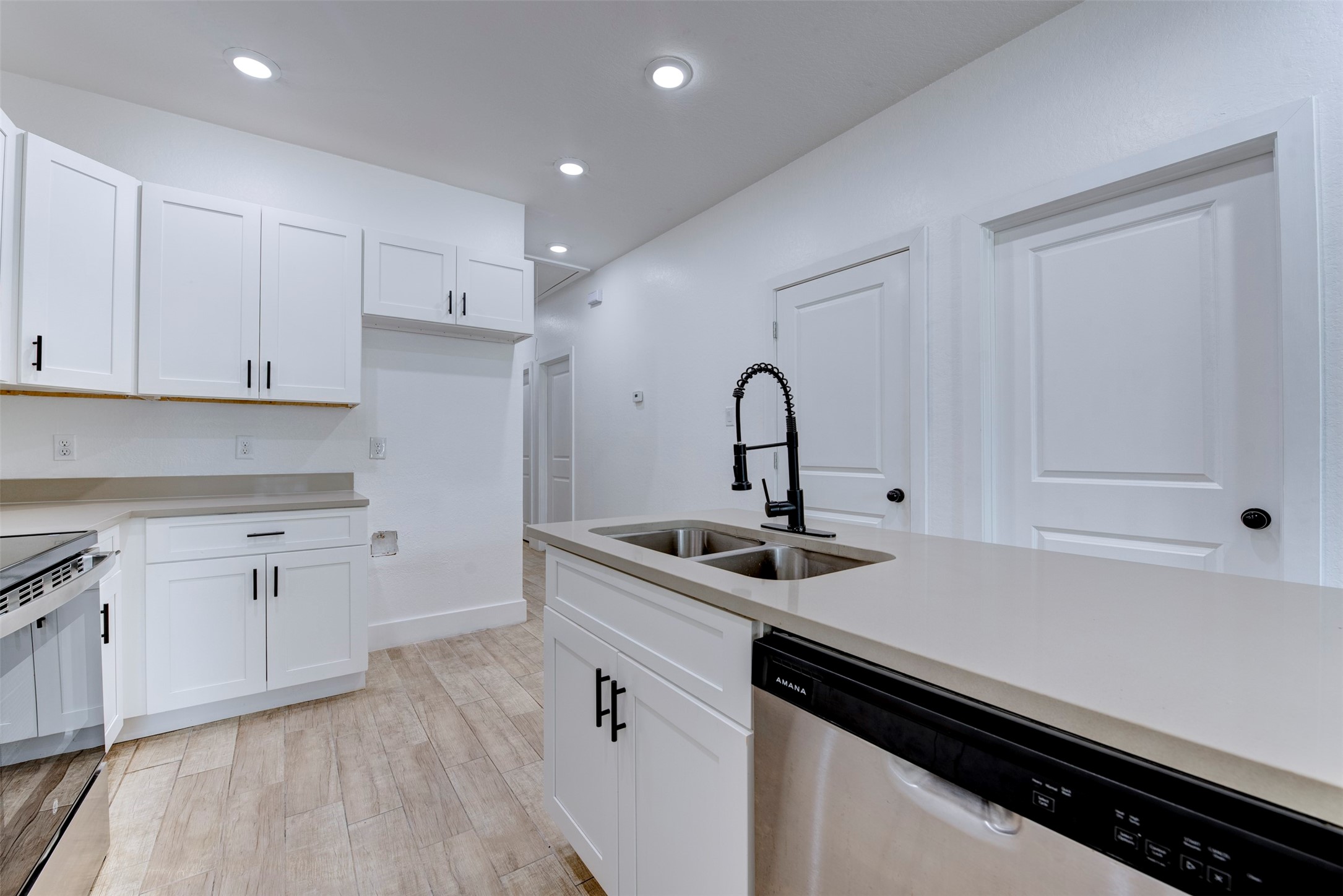 5121 Southwind Street, Unit B Houston, TX 77033 - Photo 14 of 24 a kitchen with white cabinets appliances and a sink