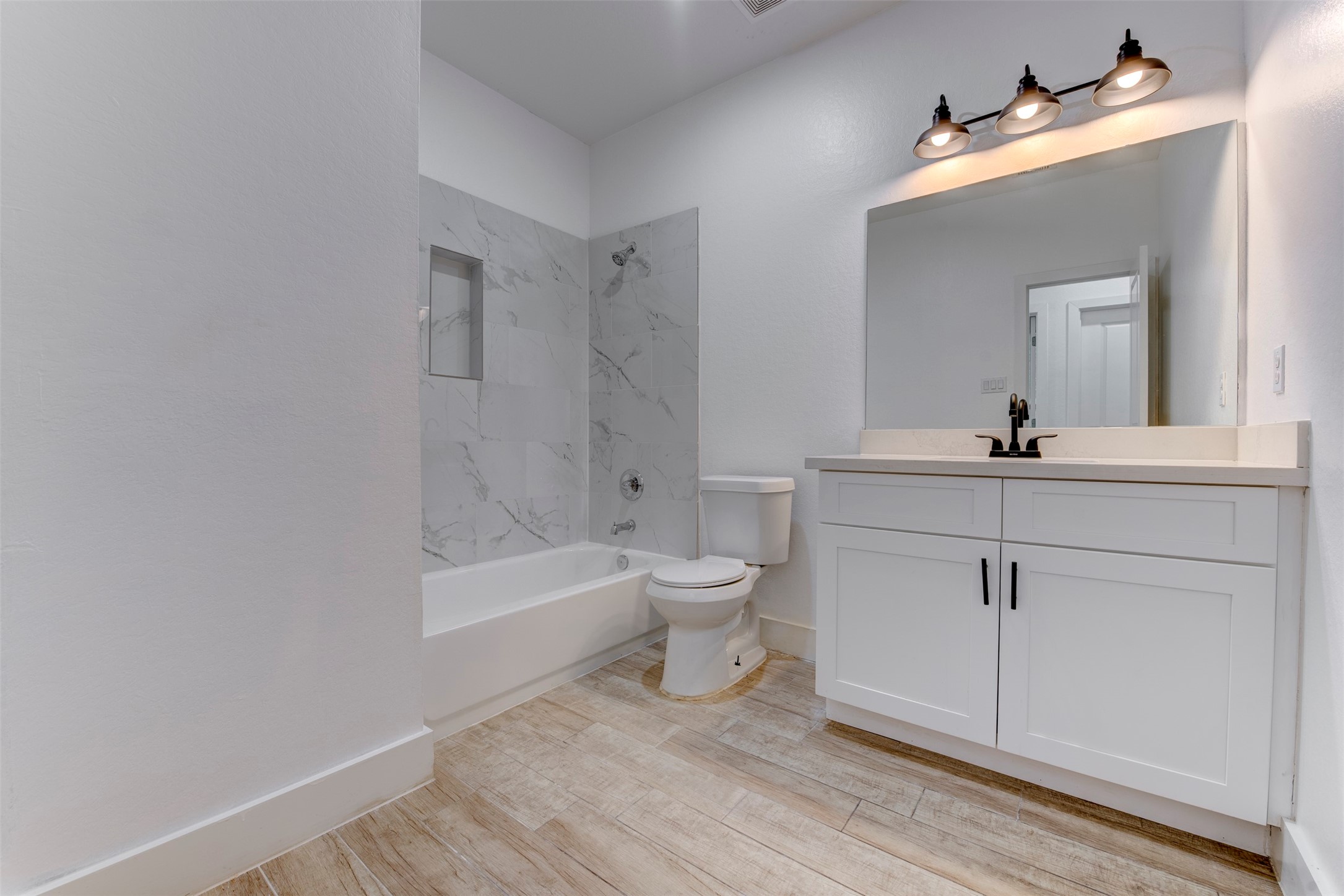 5121 Southwind Street, Unit B Houston, TX 77033 - Photo 18 of 24 a bathroom with a sink a toilet and shower
