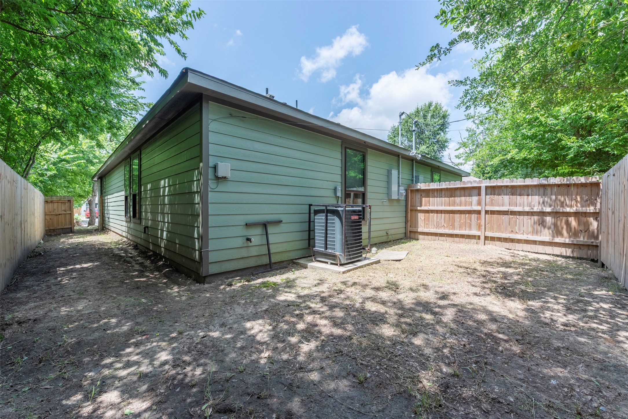 5121 Southwind Street, Unit B Houston, TX 77033 - Photo 24 of 24 a view of backyard with large trees and a barn