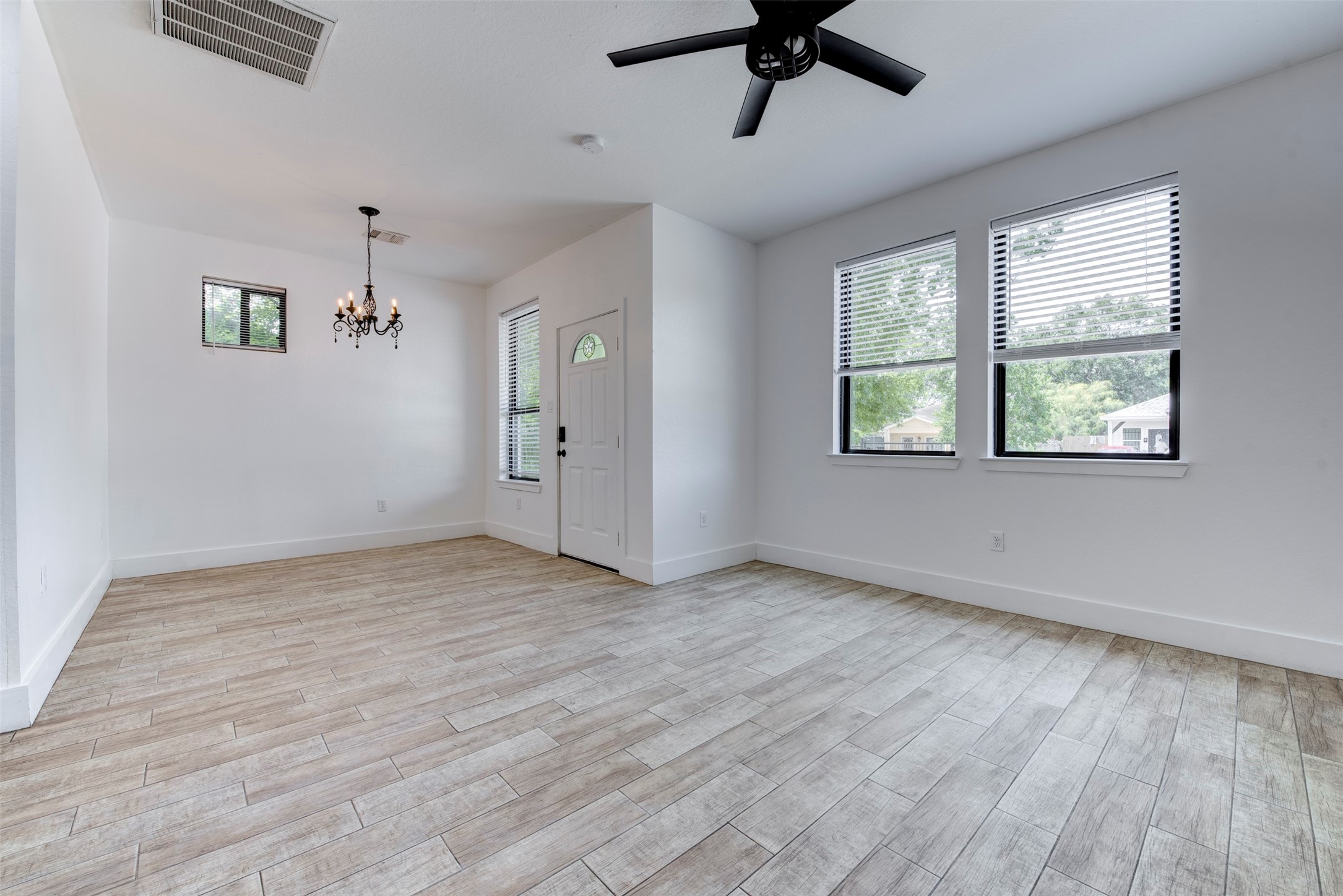 5121 Southwind Street, Unit B Houston, TX 77033 - Photo 4 of 24 a view of an empty room with a window and wooden floor