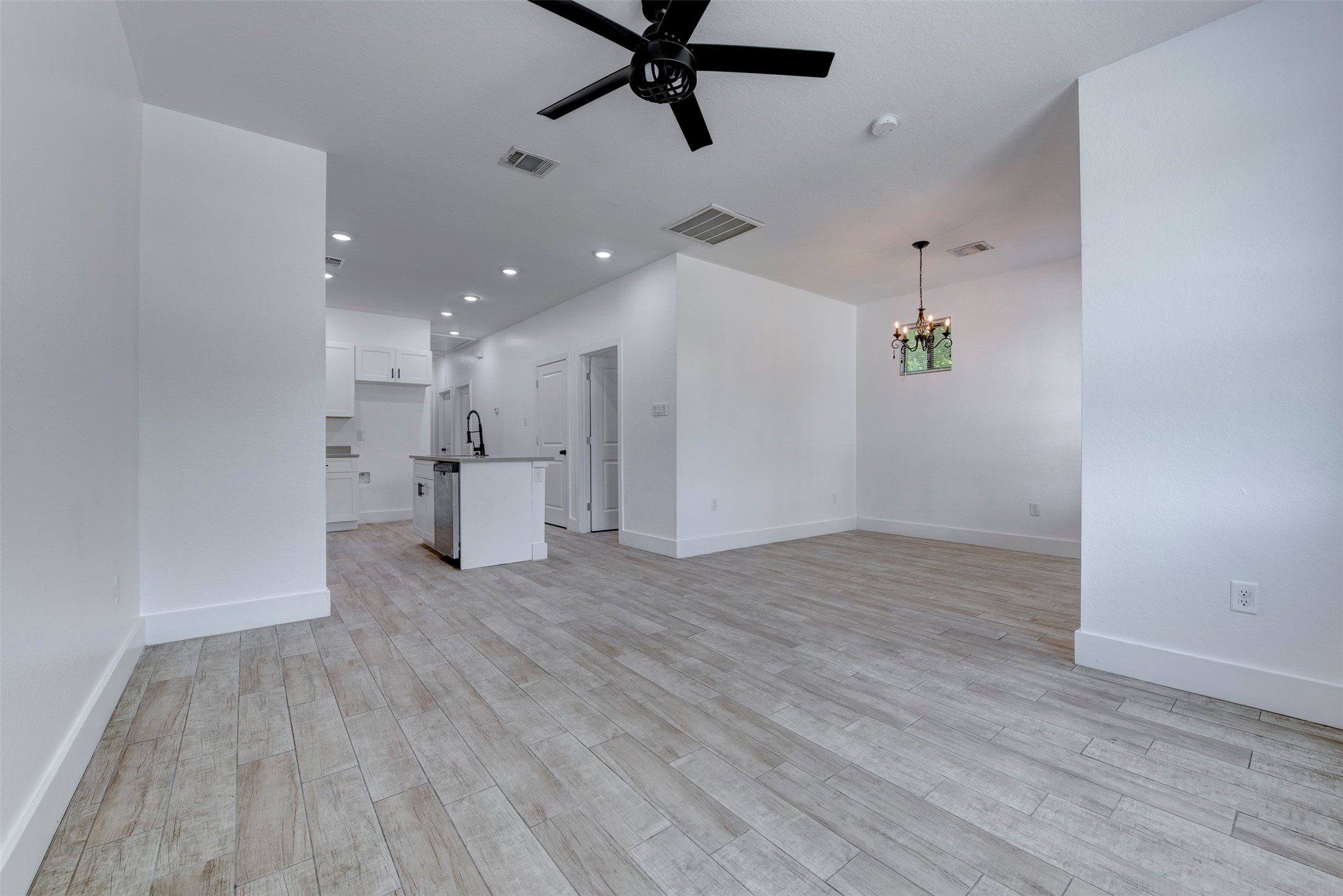 5121 Southwind Street, Unit B Houston, TX 77033 - Photo 8 of 24 wooden floor in an empty room with a window