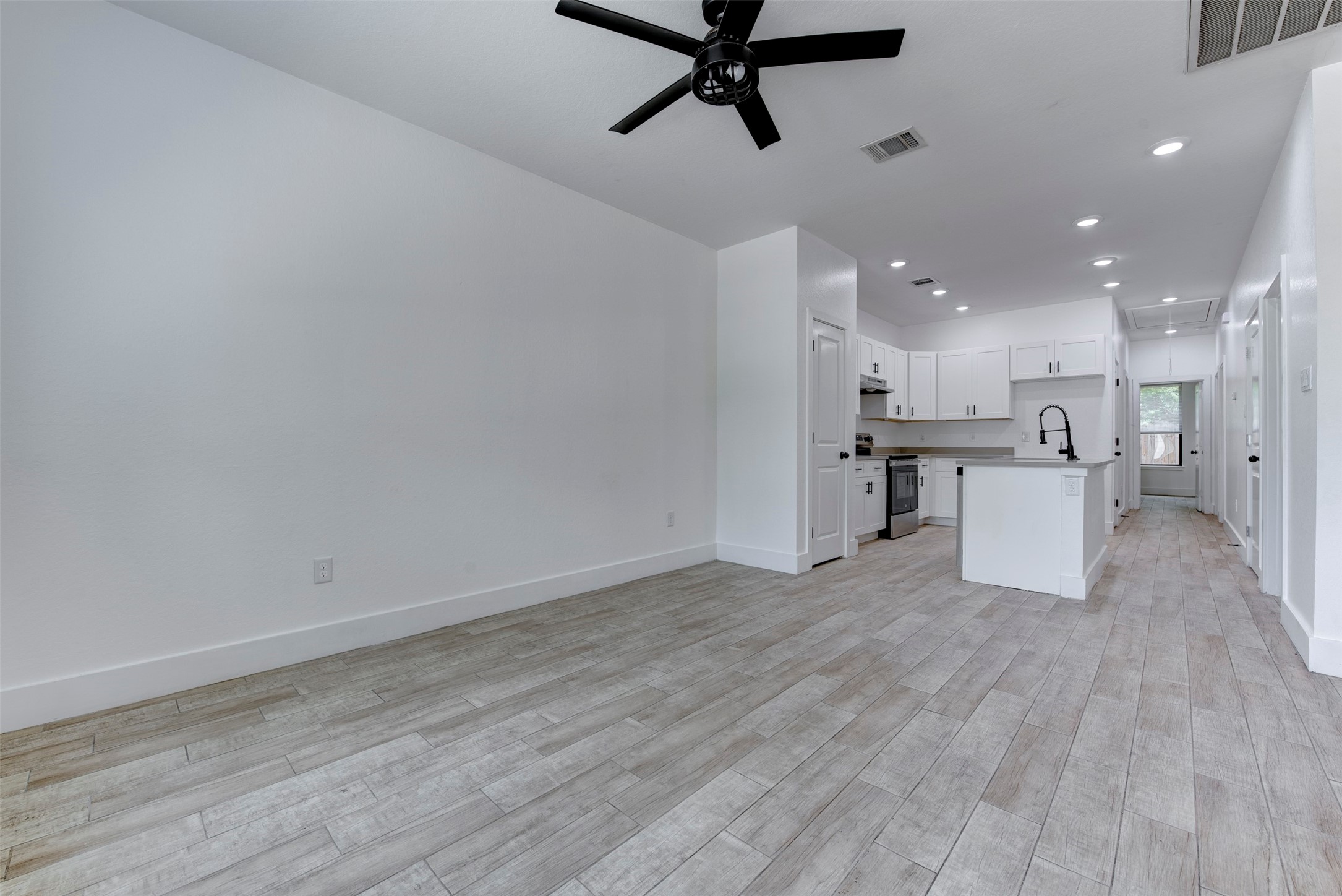 5121 Southwind Street, Unit B Houston, TX 77033 - Photo 9 of 24 a view of a kitchen with a sink and wooden floor