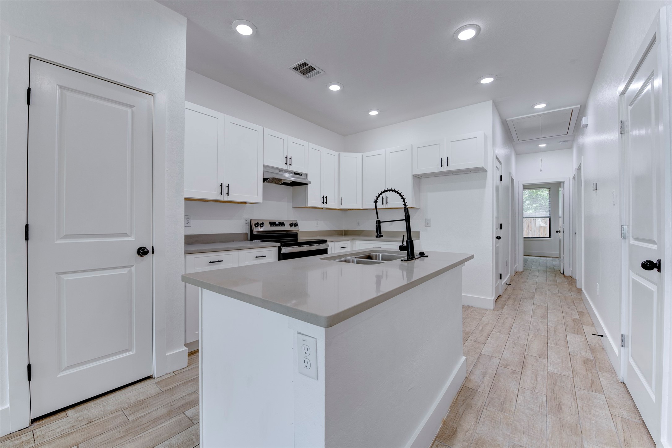 5121 Southwind Street, Unit B Houston, TX 77033 - Photo 10 of 24 a kitchen with stainless steel appliances a sink stove and refrigerator