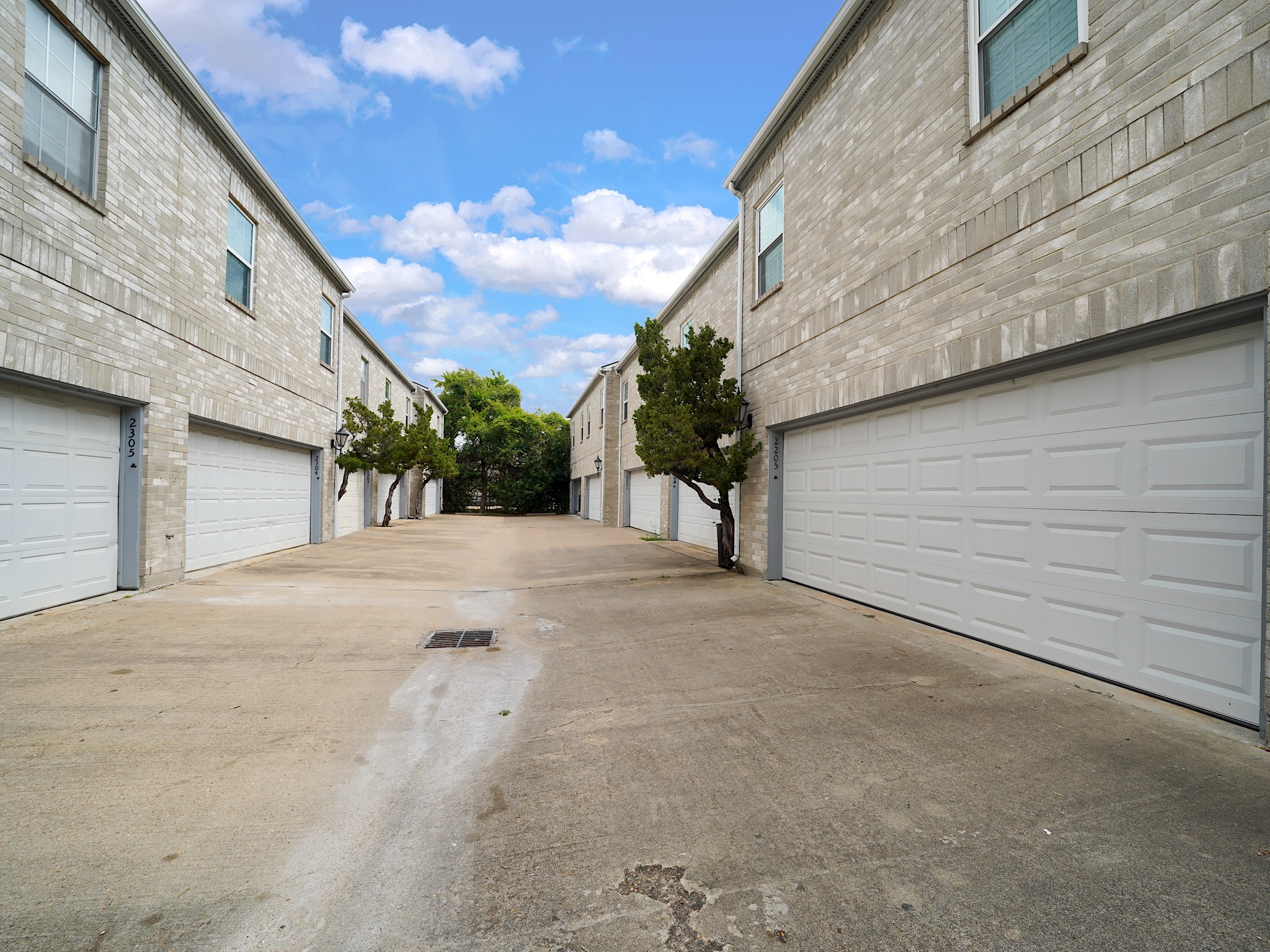 6000 Reims Road, Unit 2205 Houston, TX 77036 - Photo 30 of 35 Rear-entry garage with convenient driveway access.