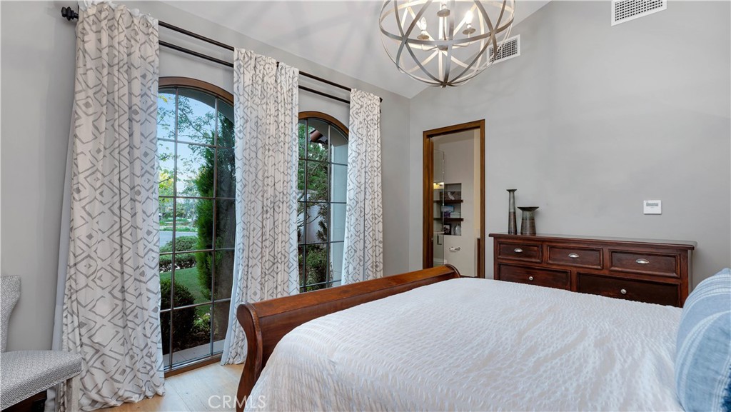 2 Thomas Road Ladera Ranch, CA 92694 - Photo 35 of 69 a bedroom with a bed a dresser and a chandelier