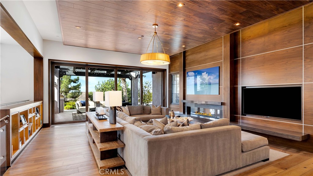 2 Thomas Road Ladera Ranch, CA 92694 - Photo 10 of 69 a living room with furniture a flat screen tv and a floor to ceiling window