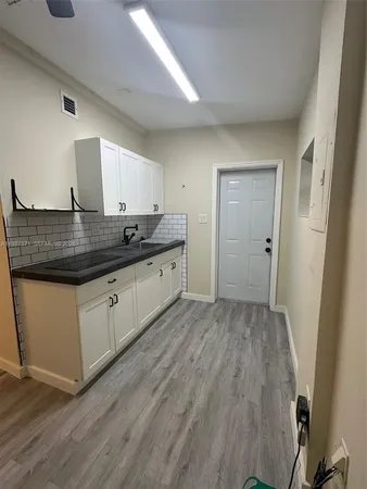 a kitchen with stainless steel appliances granite countertop a sink stove and cabinets
