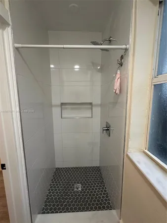 a bathroom with a glass shower door