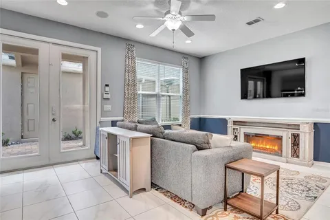 a living room with furniture a flat screen tv and a fireplace