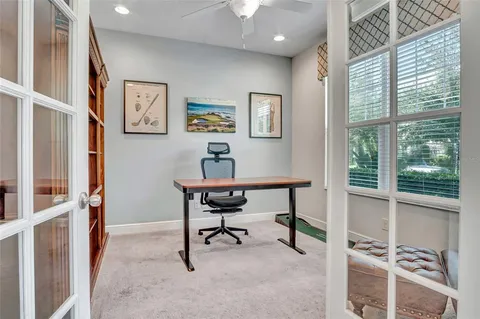 a view of a workspace with furniture and a window