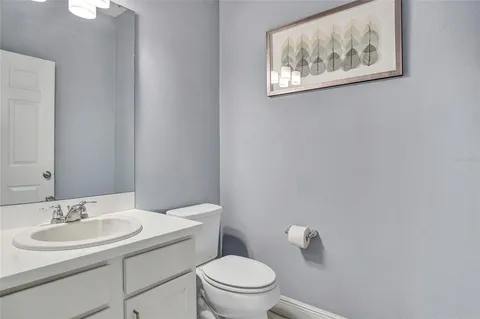 a bathroom with a sink toilet and a mirror