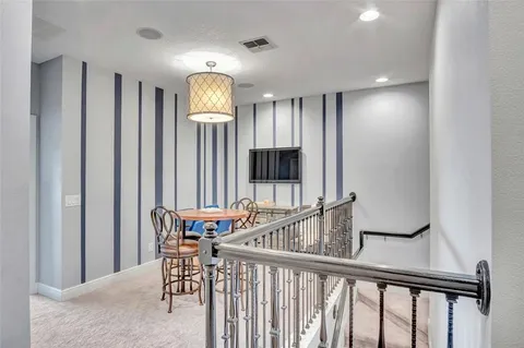 a view of a hallway with furniture and windows
