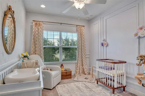 a bedroom with furniture and a large window