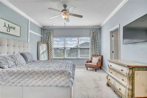 a bedroom with a bed and a large window